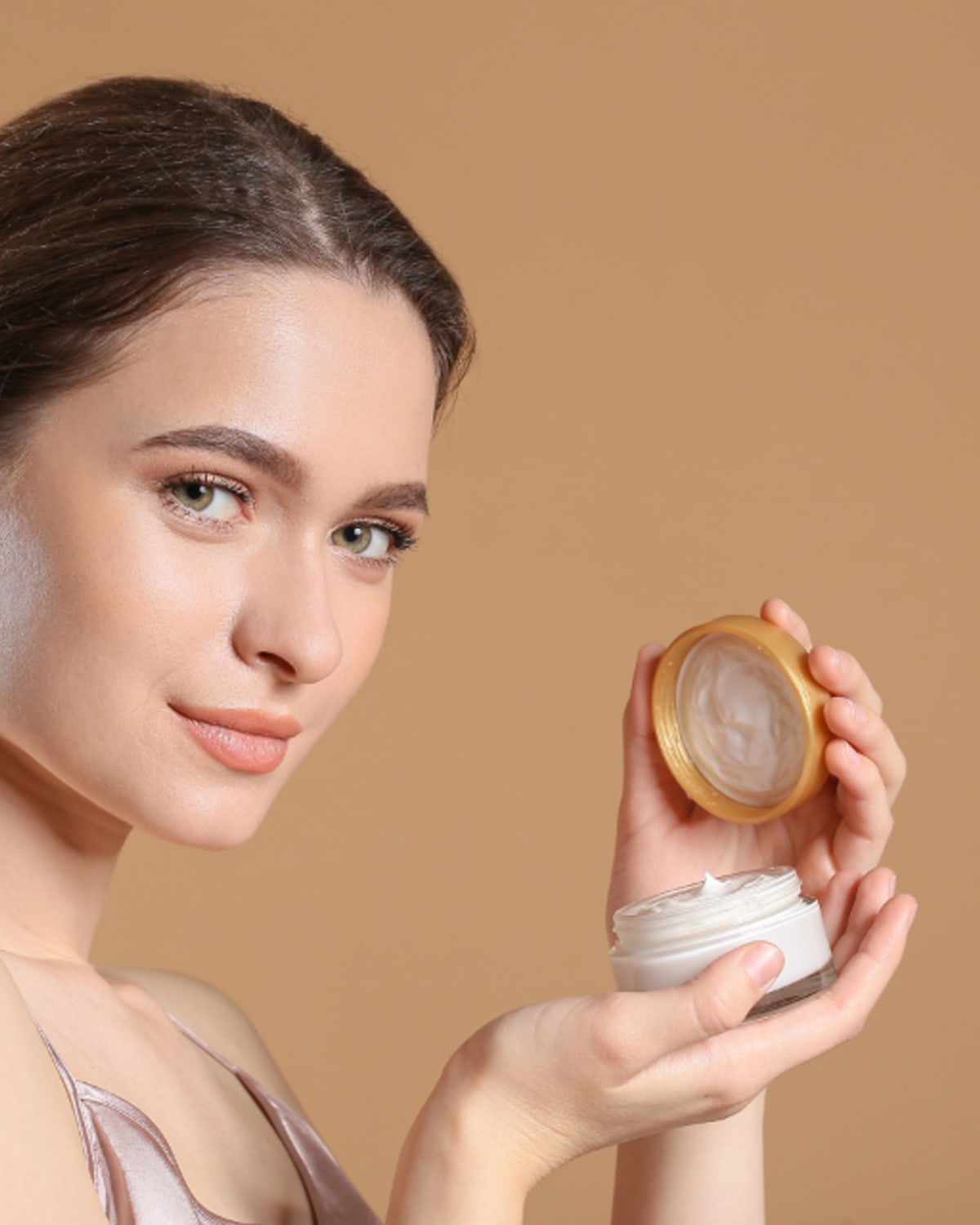 Woman reading a niacinamide serum label at home